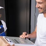 close-up-smiley-man-receiving-box_23-2149103401